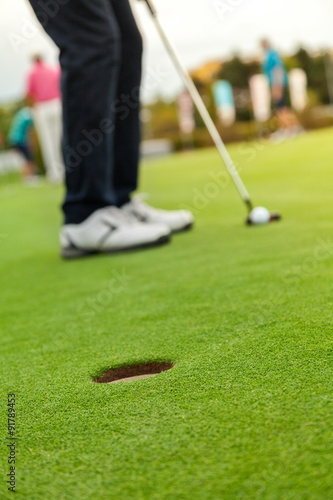 Golf player at the putting green