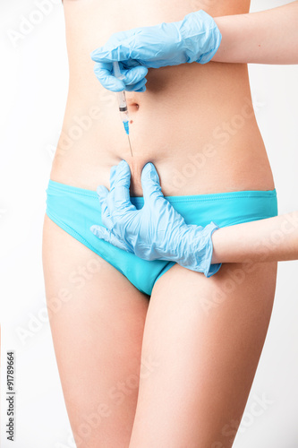 Doctor in blue gloves sterile injected into the abdomen © Aleksei Lazukov