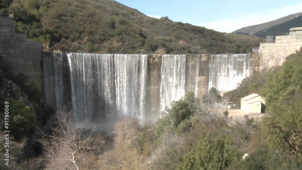 Wide zoom out of water spilling over the Matilija Dam after a rain in Ojai, California. Wide zoom out of water spilling over the Matilija Dam after a rain in Ojai, California.