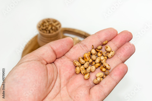 Soy beans in the hand over white