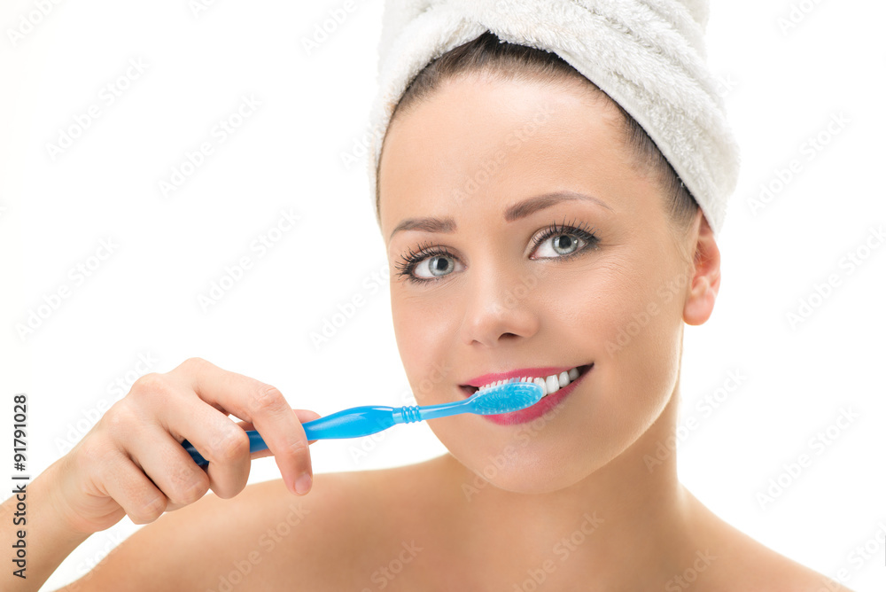 Portrait of Young cute woman brushing her teeth. Looking at camera. Close-up. Portrait of Young cute woman brushing her teeth. Looking at camera. Close-up.