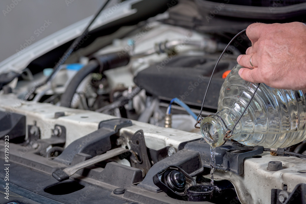 Adding water to an automotive radiator Adding water to an automotive radiator