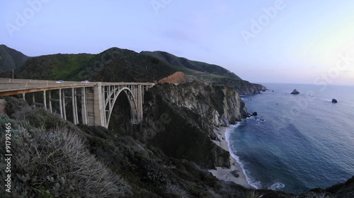 Time lapse at dusk on the historic Bixby Creek Bridge and the Big Sur Coast in Big Sur, California.