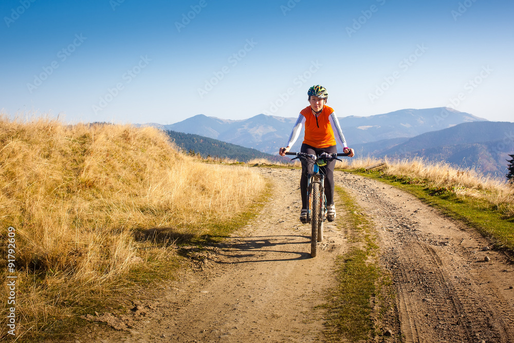 Biker riding in autumn mountains