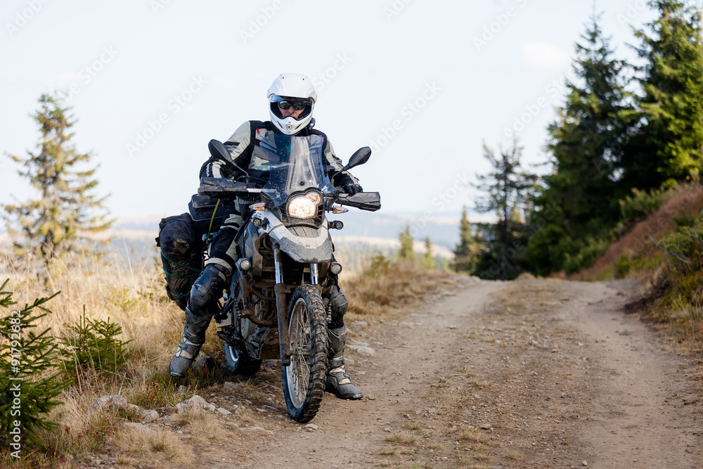 Motorbiker travelling in autumn mountains Motorbiker travelling in autumn mountains