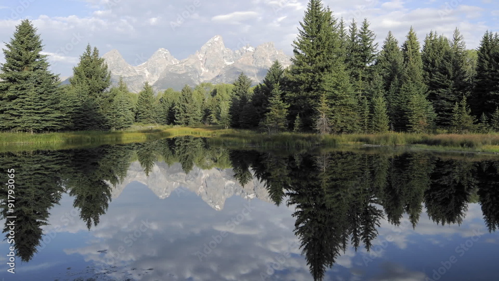 Time lapse motion of clouds, mountains and forest reflecting at Schwabacher Landing in Grand Teton National Park, Wyoming. Time lapse motion of clouds, mountains and forest reflecting at Schwabacher Landing in Grand Teton National Park, Wyoming.