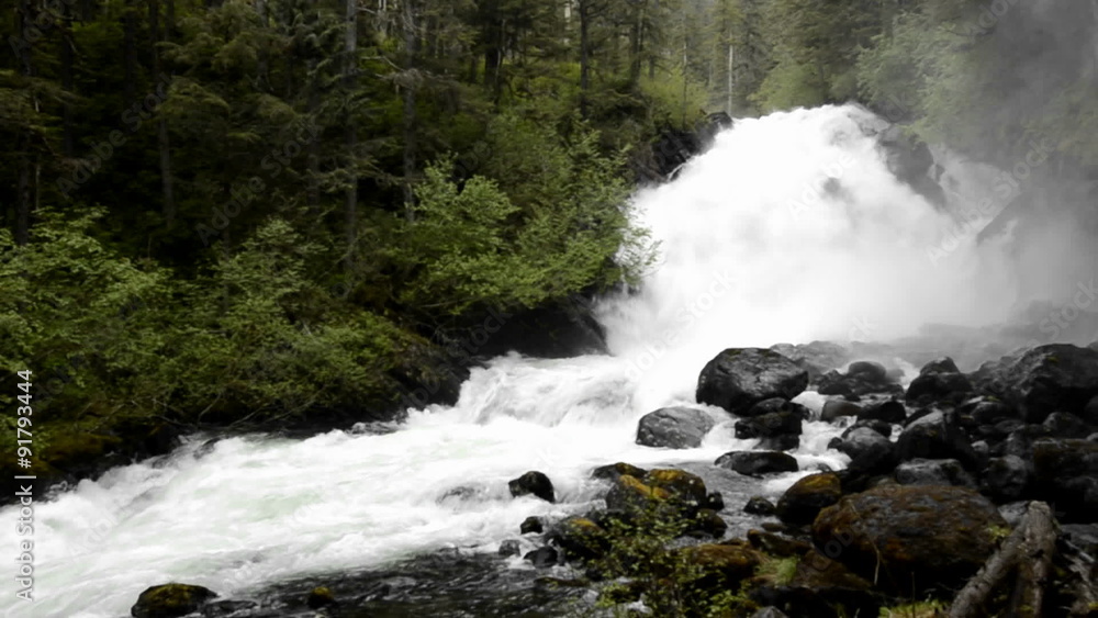 Pan of spring melt water flowing over Cascade Creek waterfall in Thomas Bay, Southeast Alaska. Pan of spring melt water flowing over Cascade Creek waterfall in Thomas Bay, Southeast Alaska.