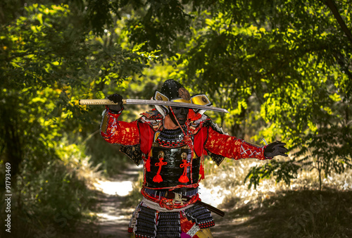 Samurai in ancient armor  with a sword ready to attack