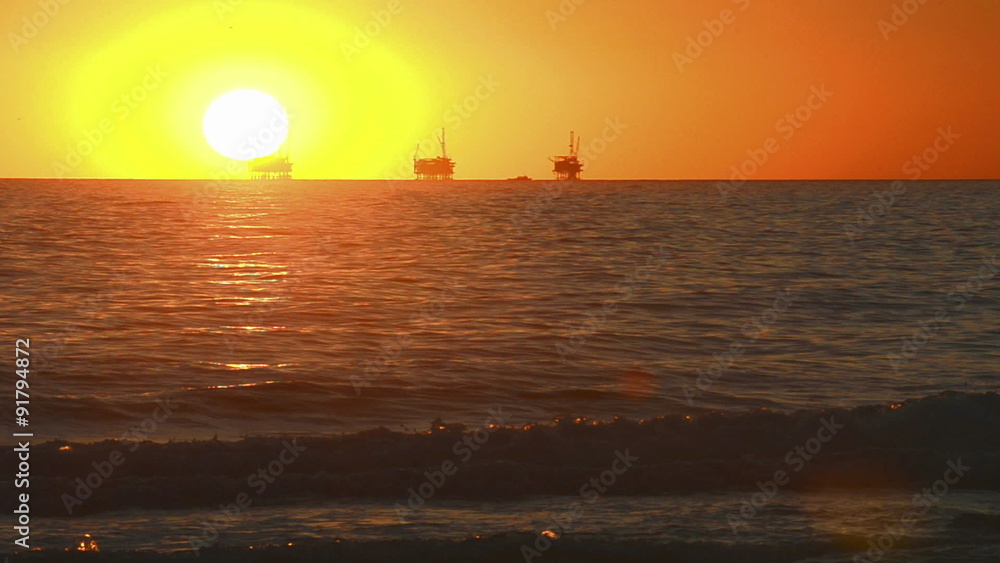 Winter sunset over the Pacific Ocean behind three oil platforms off of the Carpinteria coast near Santa Barbara, California. Winter sunset over the Pacific Ocean behind three oil platforms off of the Carpinteria coast near Santa Barbara, California.