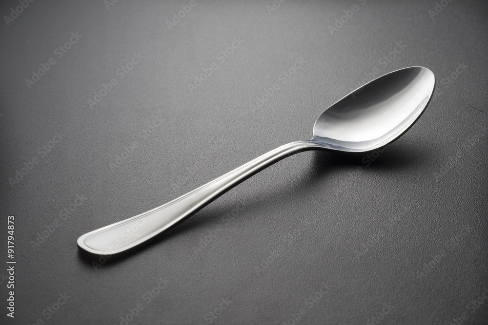 Metal spoon on black background Metal spoon on black background