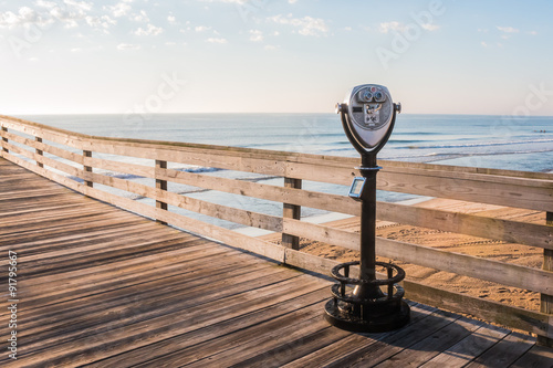 Sightseeing Binoculars with on the Virginia Beach Fishing Pier with Beach Background photo