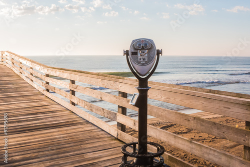 Coing-Operating Sightseeing Binoculars with Beach Background on the Virginia Beach Fishing Pier