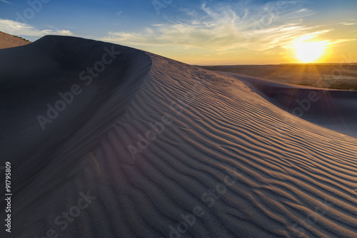 Fototapeta Naklejka Na Ścianę i Meble -  Sunset over rippled sand dune in Idaho