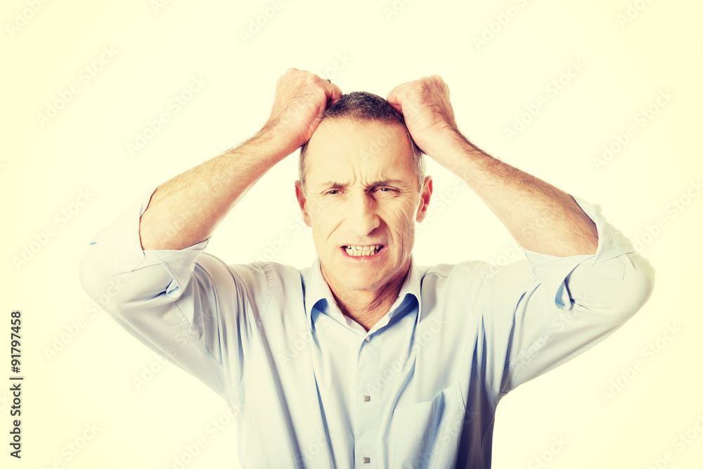 Frustrated man pulling his hair Frustrated man pulling his hair