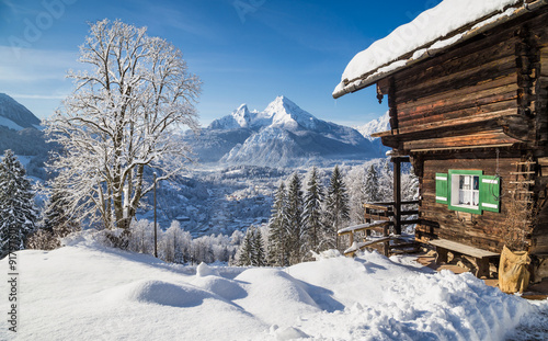 Winter wonderland in the Alps with traditional mountain chalet