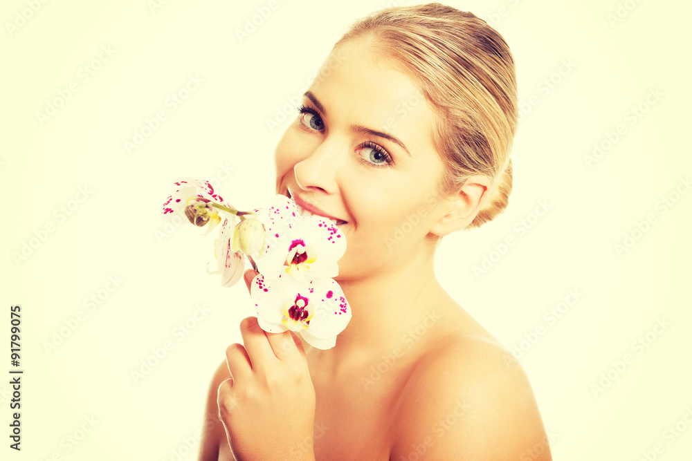 Fototapeta premium Topless woman with an orchid flower