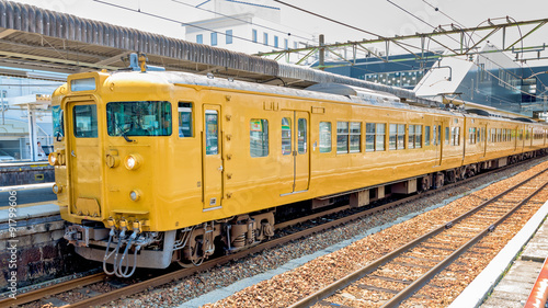 Japan train station with yellow railcars