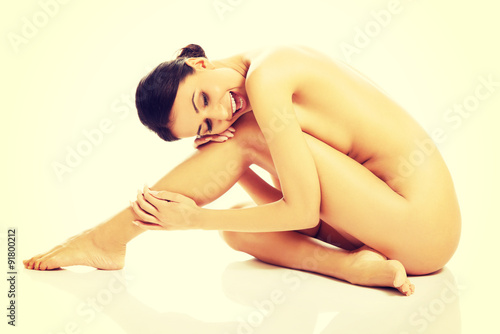 Slim spa woman sitting curled up