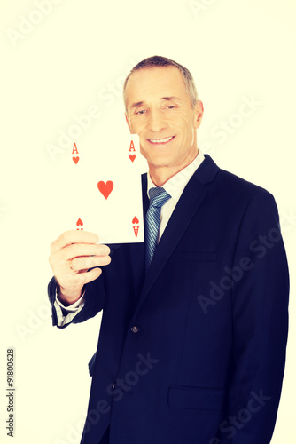 Elegant businessman with red ace card