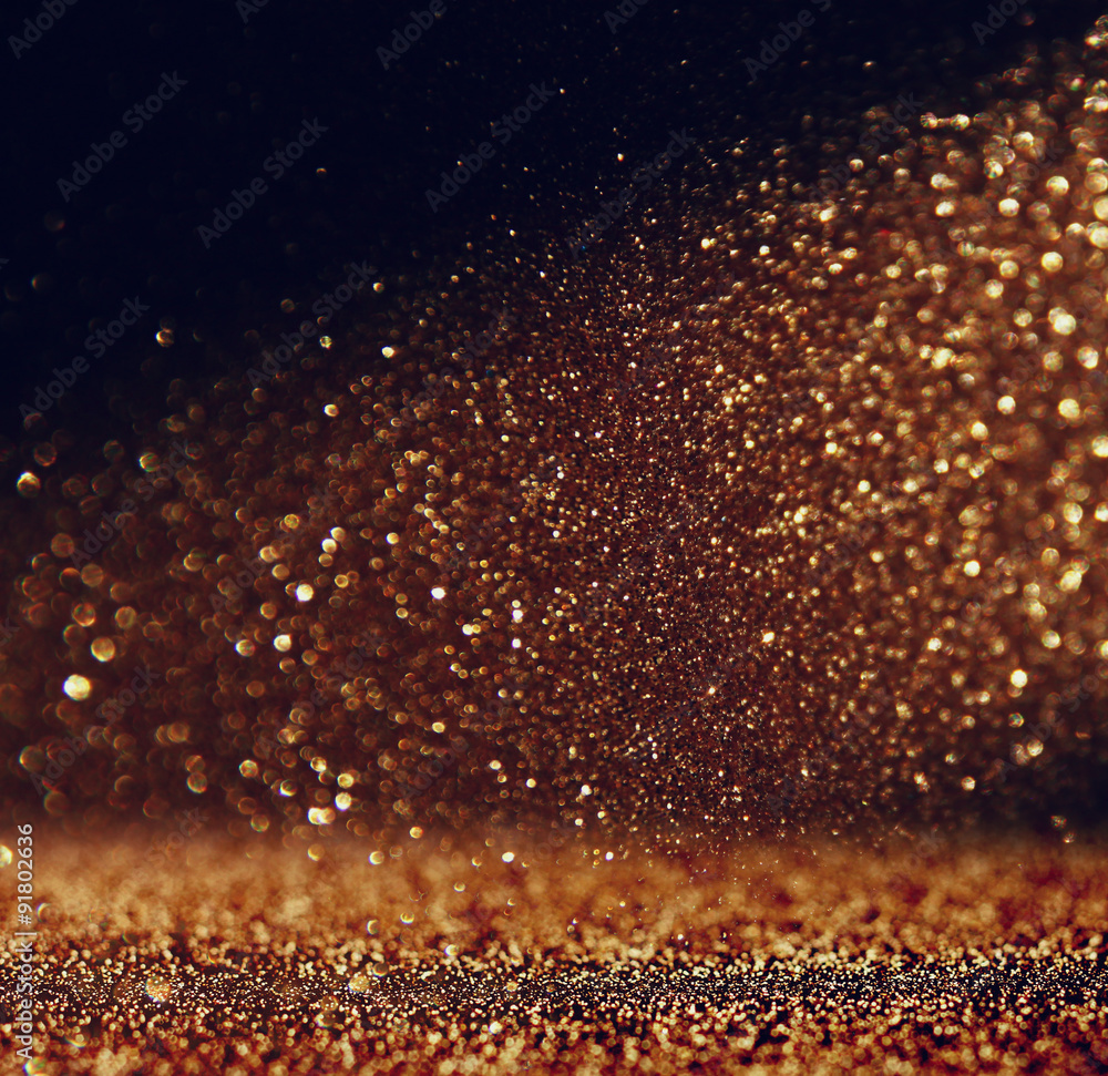 glitter vintage lights background. gold and black. defocused
