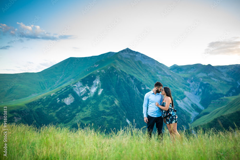 beautiful young couple hugging in the mountains