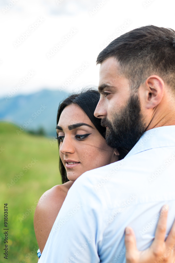 beautiful young couple hugging in the mountains beautiful young couple hugging in the mountains