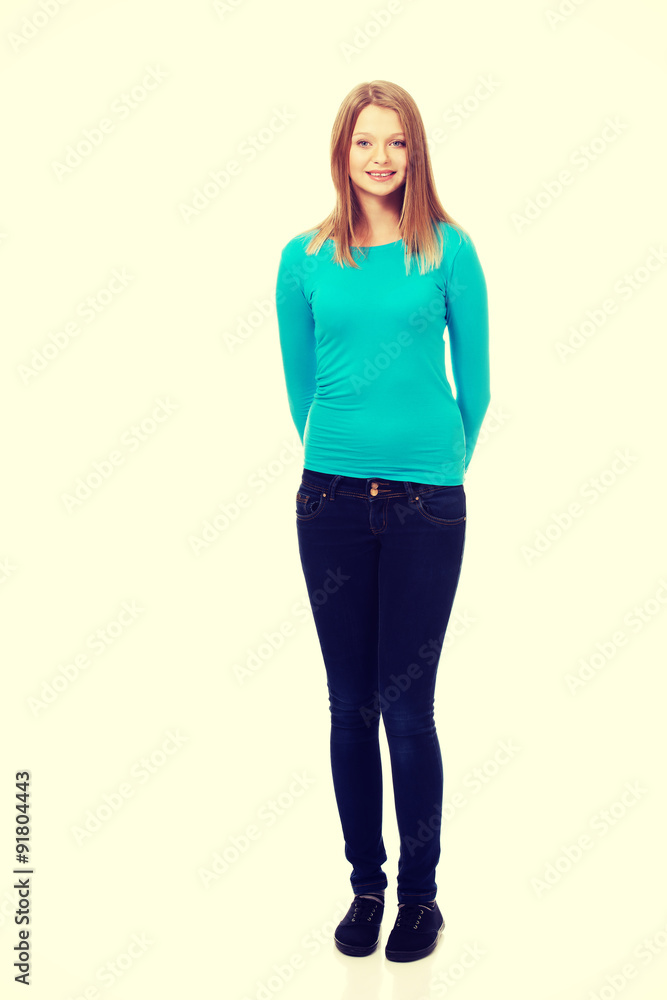 Young woman standing with toothy smile Young woman standing with toothy smile