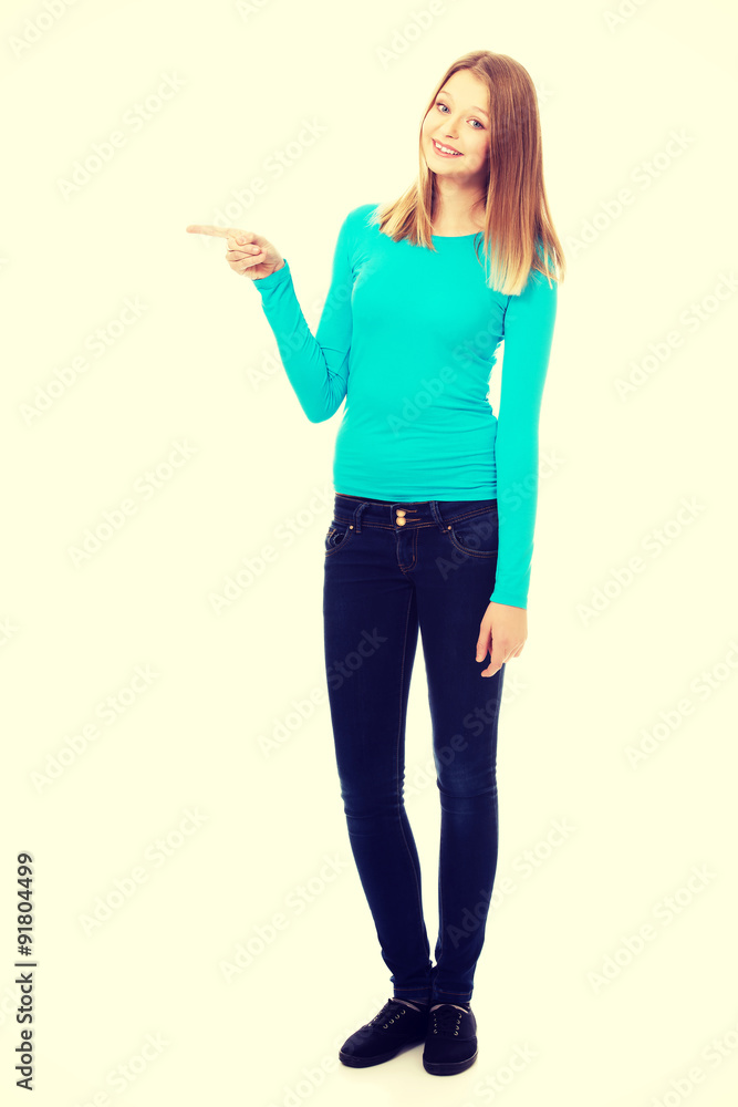 Young woman pointing to the left Young woman pointing to the left
