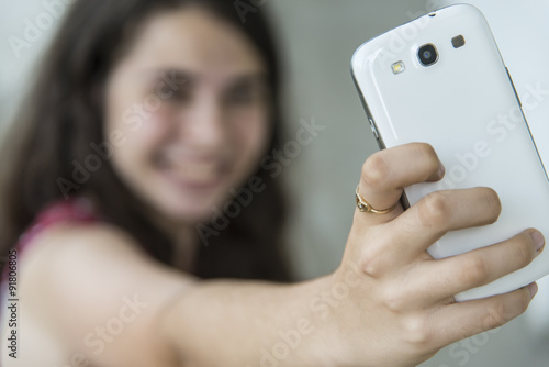 Girl taking a selfie with her phone