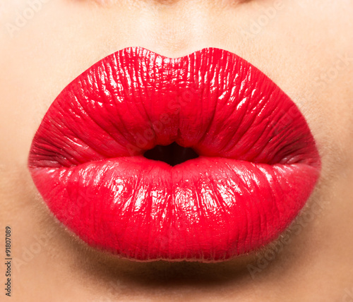 Woman's lips with red lipstick and  kiss gesture