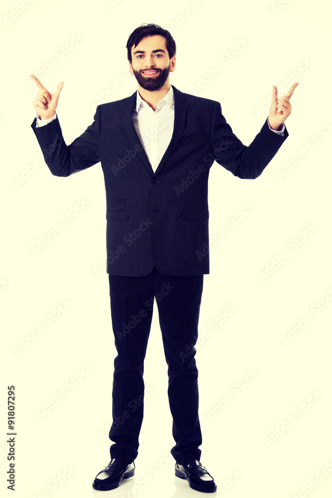 Businessman showing the size with two fingers. Businessman showing the size with two fingers.
