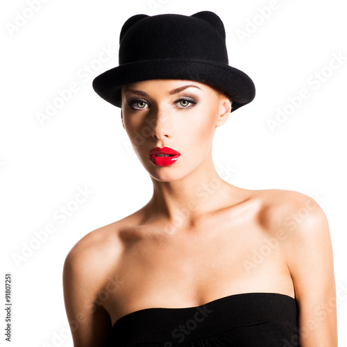 Fashion portrait of a beautiful young girl wearing a black hat. © Valua Vitaly