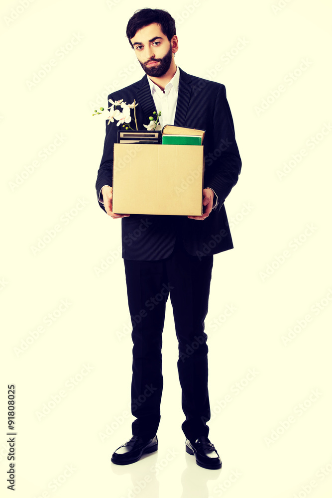 Businessman holding box with personal belongings. Businessman holding box with personal belongings.