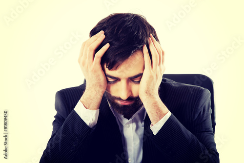 Businessman sitting at the desk. © Piotr Marcinski