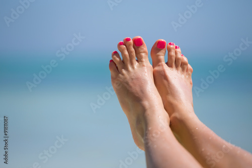 Bare woman's feet on the beach © Kaspars Grinvalds