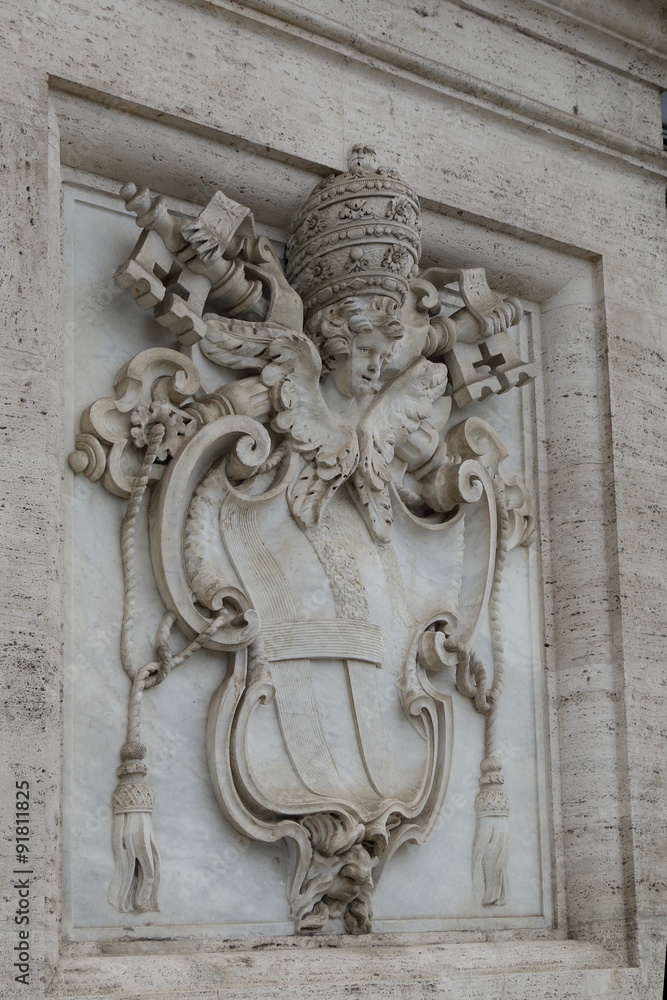 Bas relief of Papal Coat of Arms on white marble