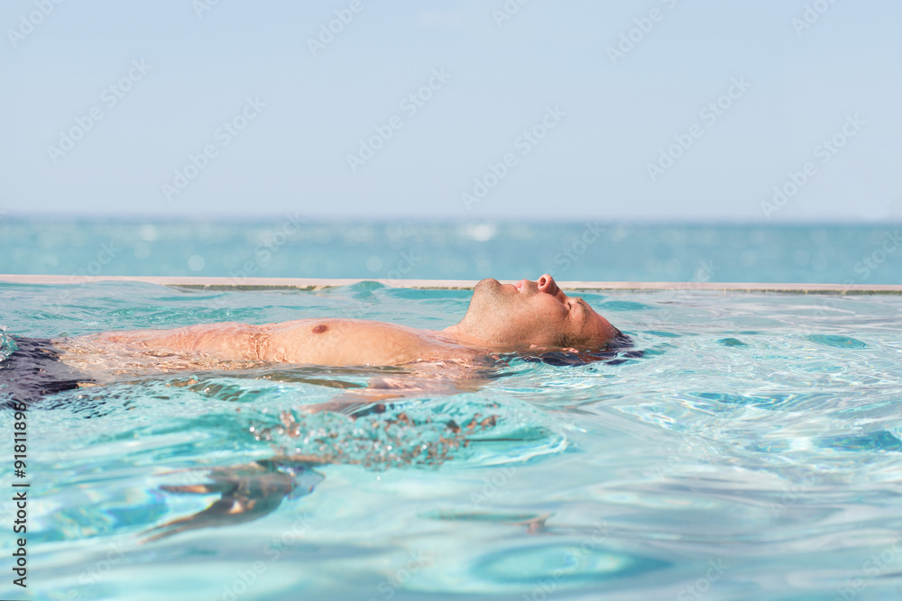 Man relaxing in the swimming pool