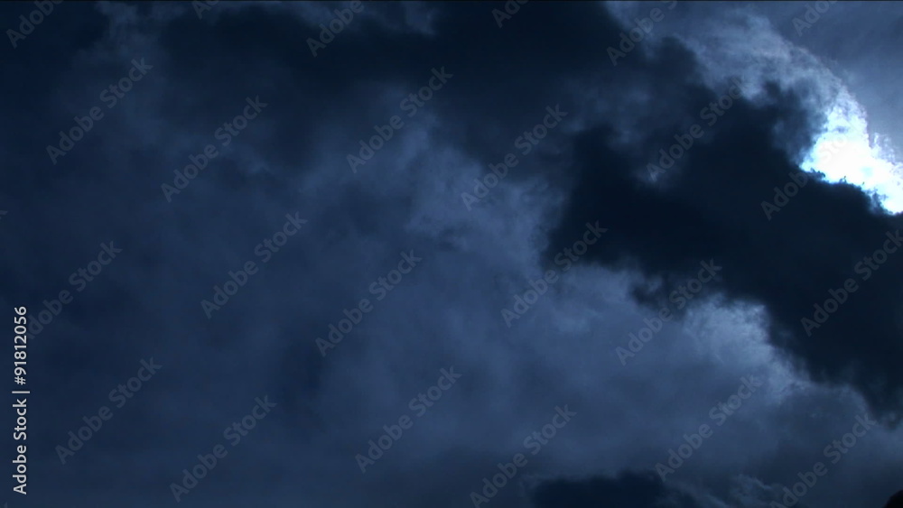 Pan onto peak in pale blue light with clouds Pan onto peak in pale blue light with clouds