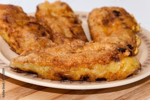Fried paprika stuffed with cheese and served