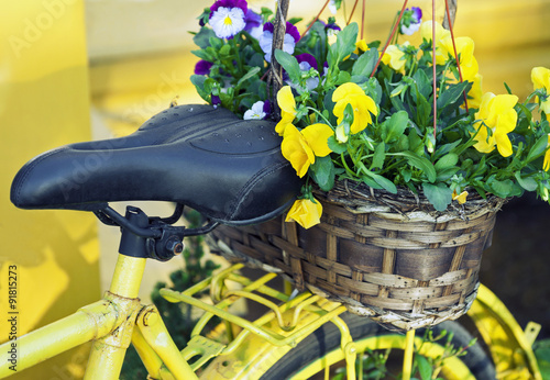 Yellow bicycle decorated with flowers