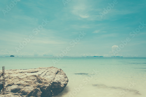 blue sky with sea and rock - soft focus with film filter