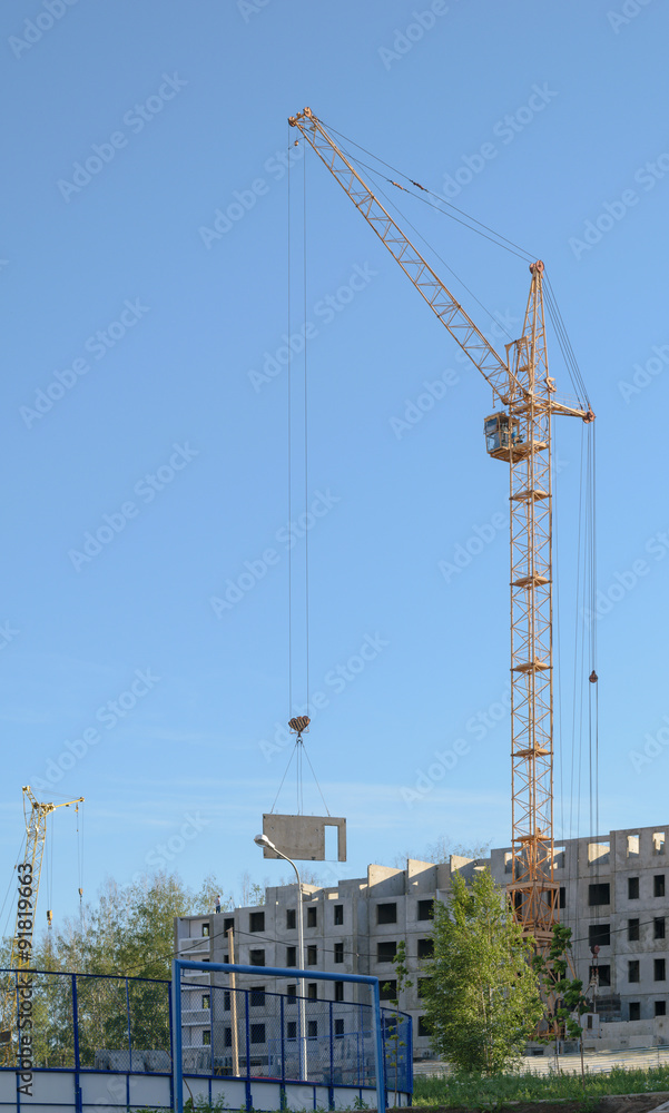 Two cranes on the construction of the house