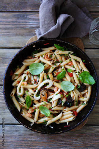 pasta with seafood and basil leaves
