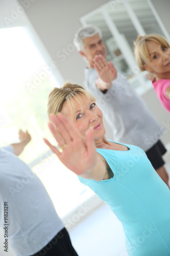 Senior people stretching out in fitness room