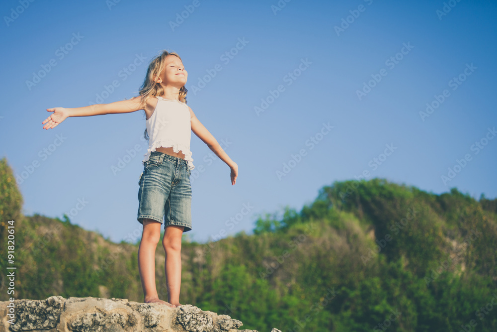 Happy little girl standing on the beach Happy little girl standing on the beach
