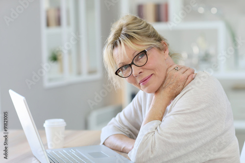 Portrait of senior woman working on laptop computer