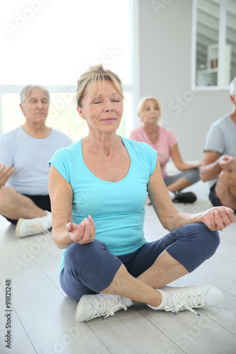 Group of senior people doing yoga exercises