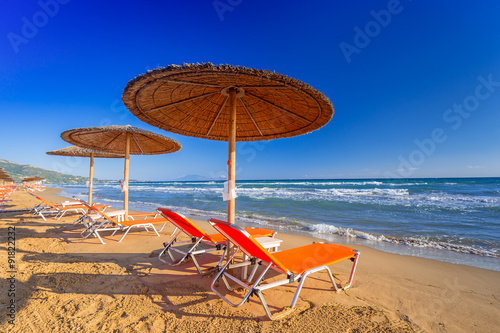Parasols and deckhcairs on the Banana Beach of Zakynthos island, Greece