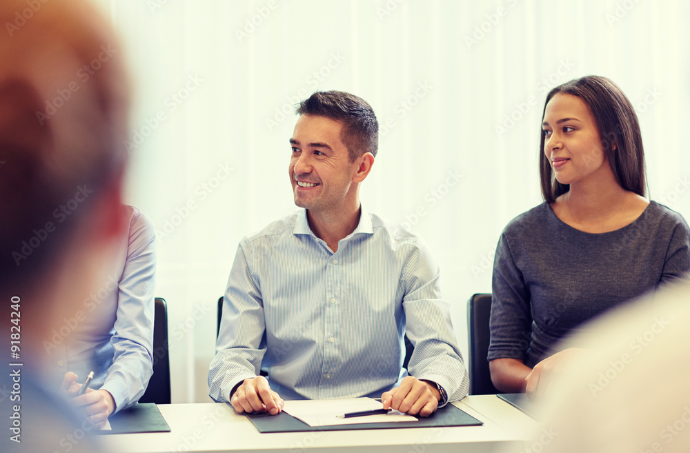 group of smiling businesspeople meeting in office group of smiling businesspeople meeting in office