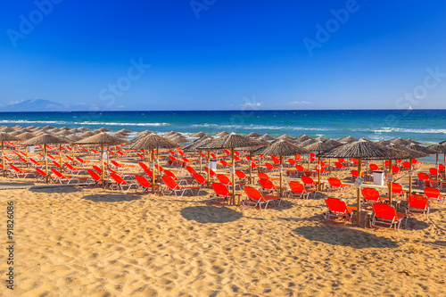 Parasols and deckhcairs on the Banana Beach of Zakynthos island, Greece